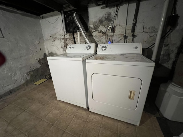 washroom with washing machine and clothes dryer and tile patterned floors