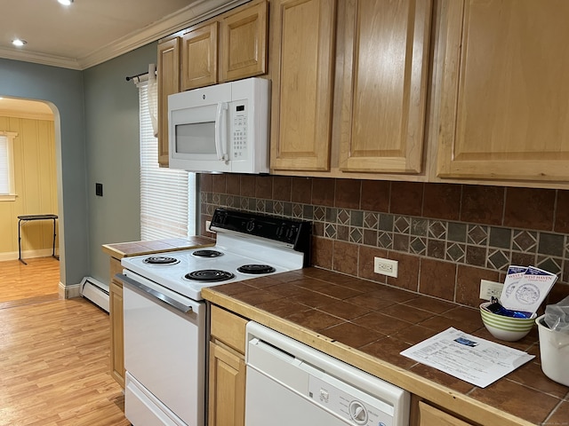 kitchen with white appliances, baseboard heating, backsplash, tile counters, and ornamental molding