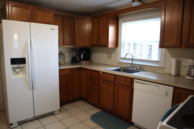 kitchen with decorative backsplash, light tile patterned flooring, white appliances, and sink