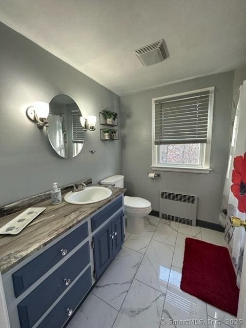 bathroom featuring a shower with curtain, vanity, toilet, and radiator