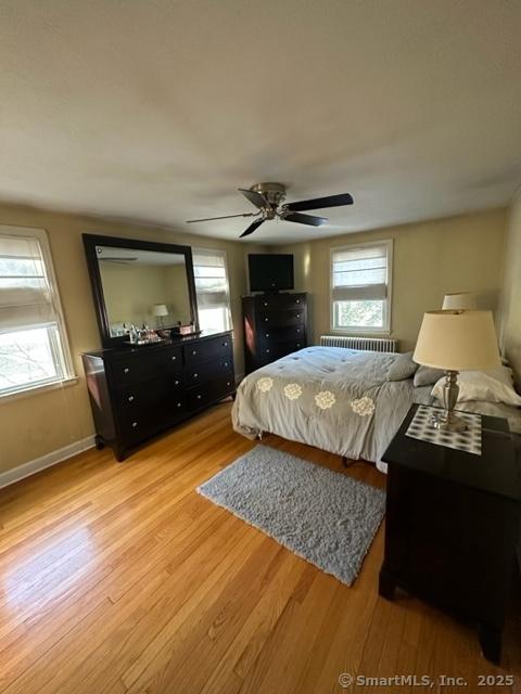 bedroom with ceiling fan and light wood-type flooring