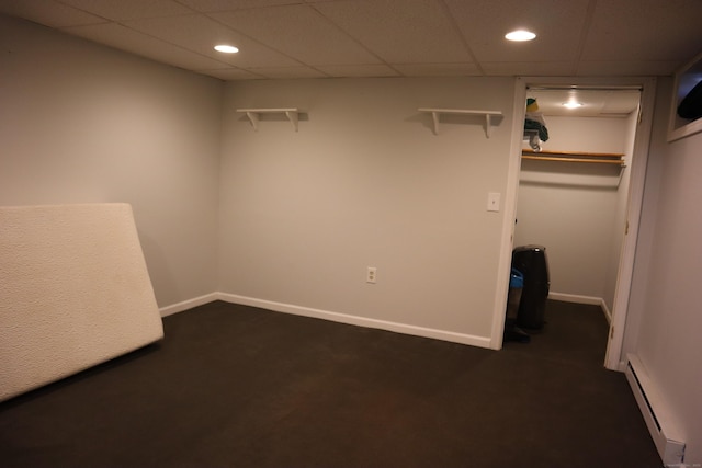 interior space with baseboard heating and a paneled ceiling