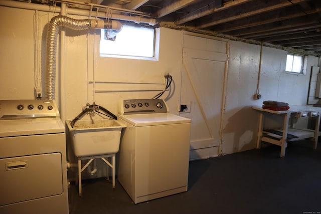 laundry area featuring washer and clothes dryer and sink