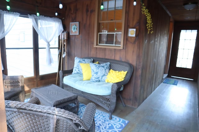 interior space with wood walls, hardwood / wood-style floors, and wooden ceiling