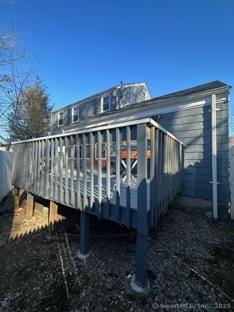 rear view of property featuring a deck