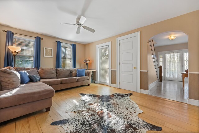 6264 Main St, Trumbull, CT 06611 - living room with arched walkways, ceiling fan, hardwood / wood-style floors, and baseboards