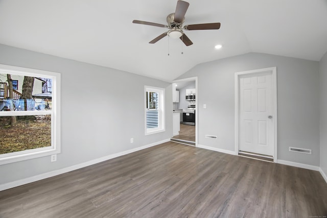 unfurnished bedroom featuring ceiling fan, dark hardwood / wood-style floors, and multiple windows