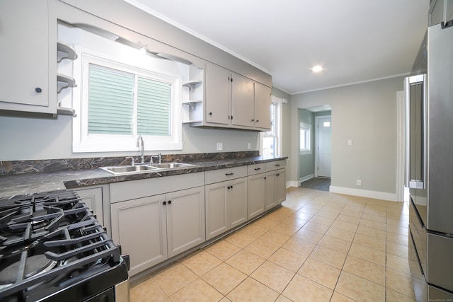 kitchen featuring sink, light tile patterned flooring, ornamental molding, and gray cabinetry