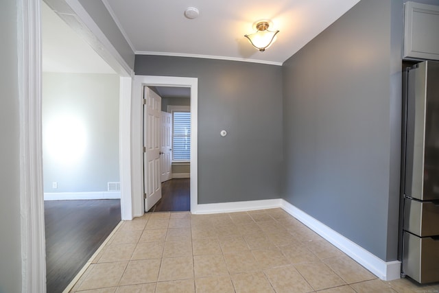 tiled spare room with crown molding