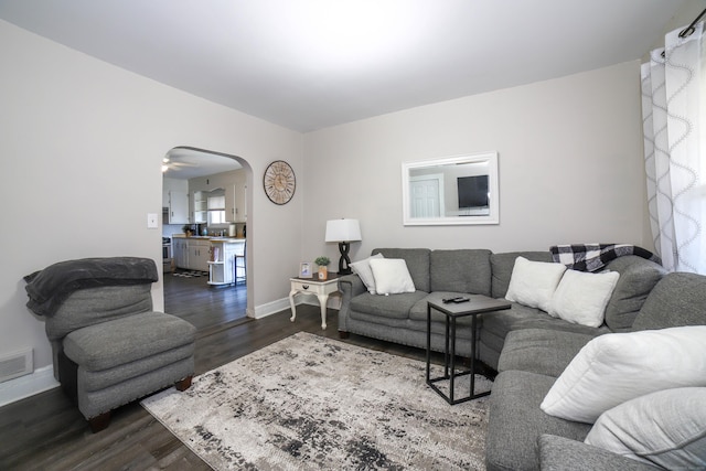 living room with ceiling fan and dark hardwood / wood-style floors