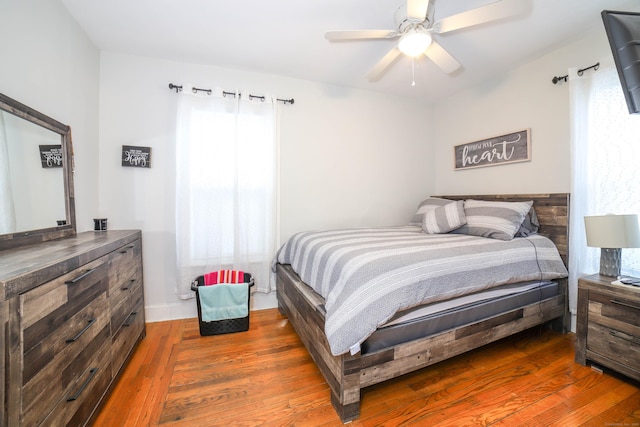 bedroom featuring ceiling fan and dark hardwood / wood-style floors