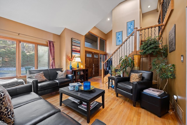 living room with light wood-type flooring and lofted ceiling