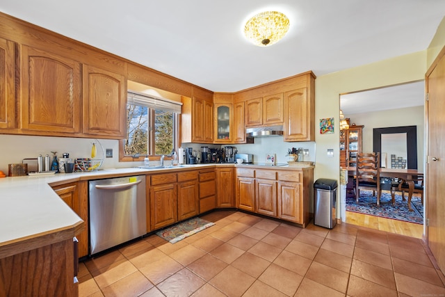 kitchen with light tile patterned floors, dishwasher, and sink