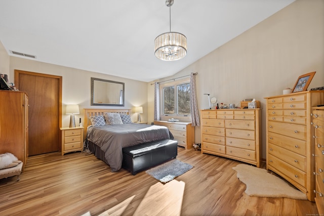 bedroom featuring light hardwood / wood-style floors and a chandelier