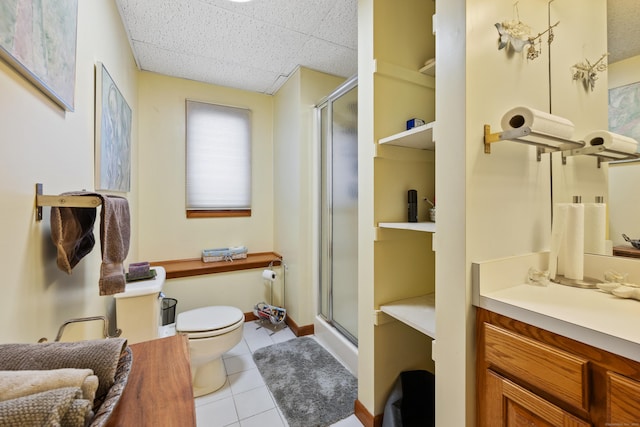 bathroom featuring a shower with shower door, a drop ceiling, vanity, and tile patterned flooring