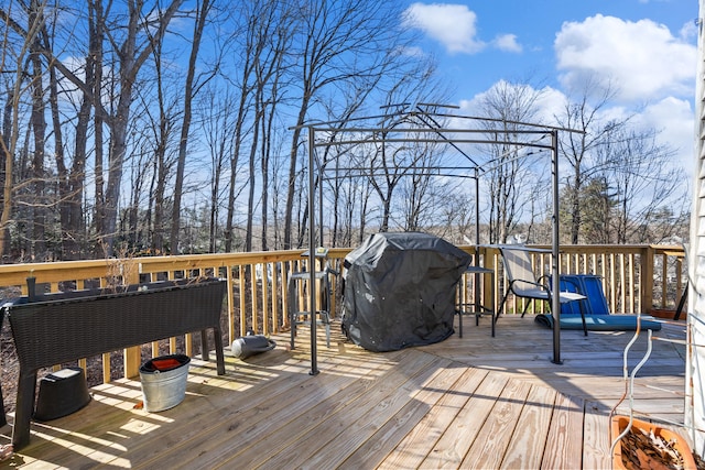 wooden terrace featuring a grill