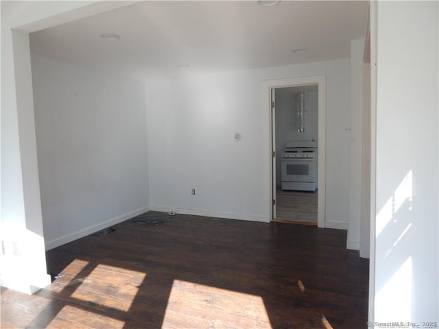 spare room featuring dark wood-type flooring