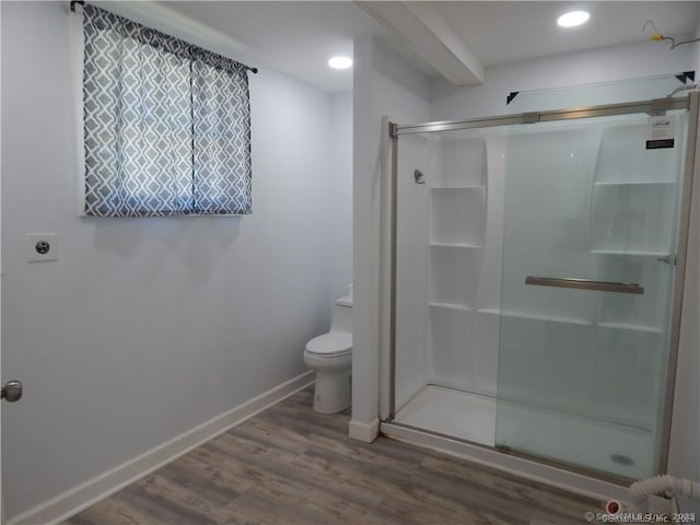 bathroom featuring hardwood / wood-style floors, an enclosed shower, and toilet