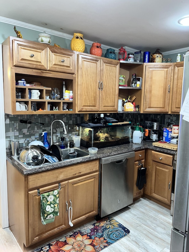 kitchen with dark stone counters, appliances with stainless steel finishes, light wood-type flooring, and backsplash