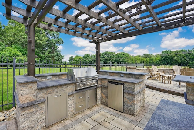 view of patio / terrace featuring a pergola, area for grilling, an outdoor fire pit, and grilling area