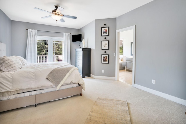 bedroom with ensuite bathroom, ceiling fan, and light colored carpet