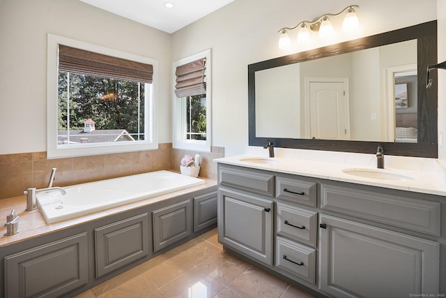 bathroom featuring tile patterned floors, vanity, and a bath