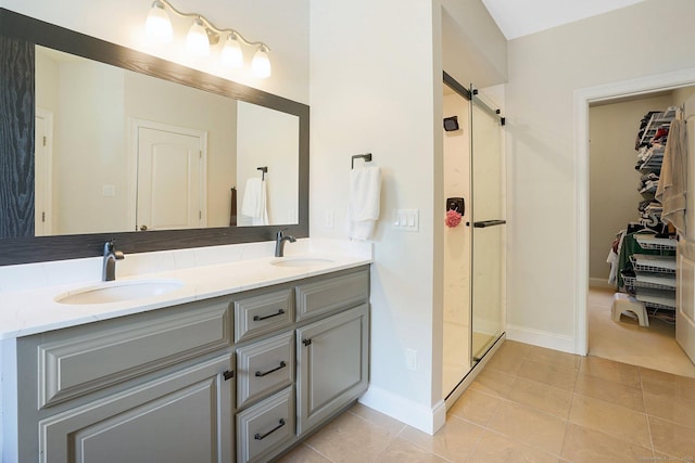 bathroom with tile patterned floors, vanity, and an enclosed shower