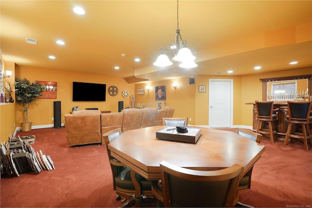 dining room with carpet and a notable chandelier