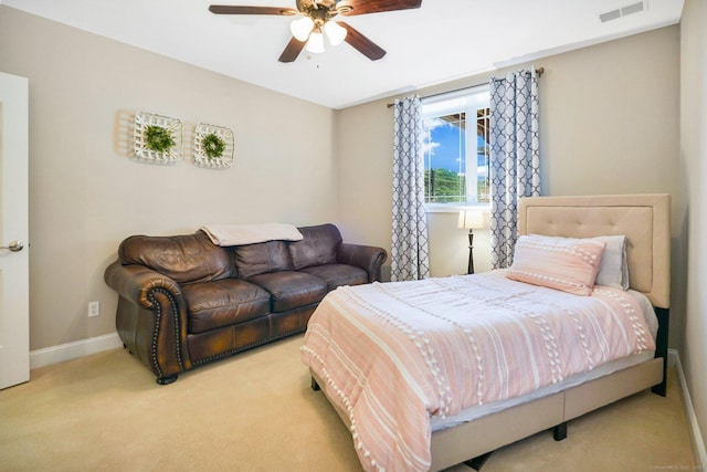 bedroom with ceiling fan and light colored carpet