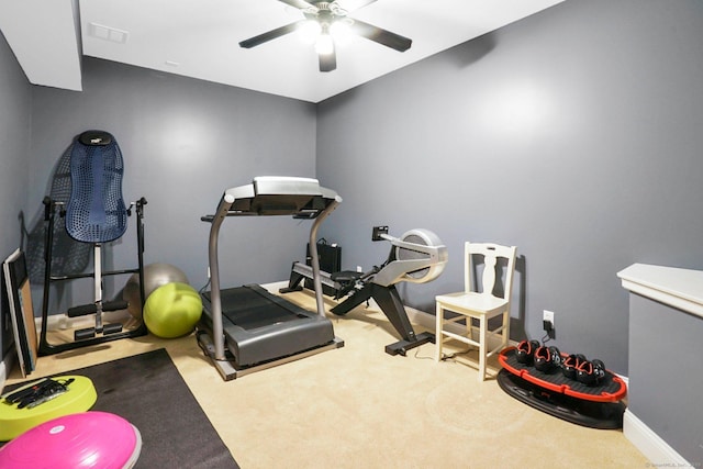 workout area featuring light carpet and ceiling fan