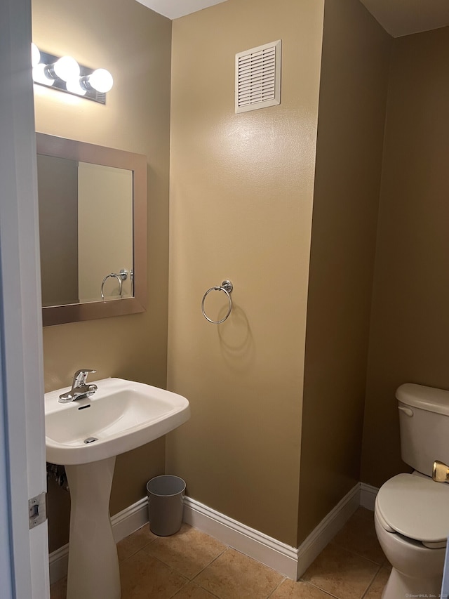 bathroom featuring tile patterned flooring, sink, and toilet