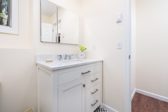 bathroom with hardwood / wood-style floors and vanity