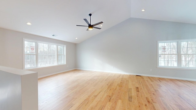 spare room featuring light wood-type flooring, visible vents, a ceiling fan, and lofted ceiling