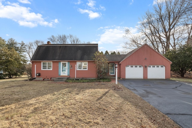 view of front of house with a front yard and a garage