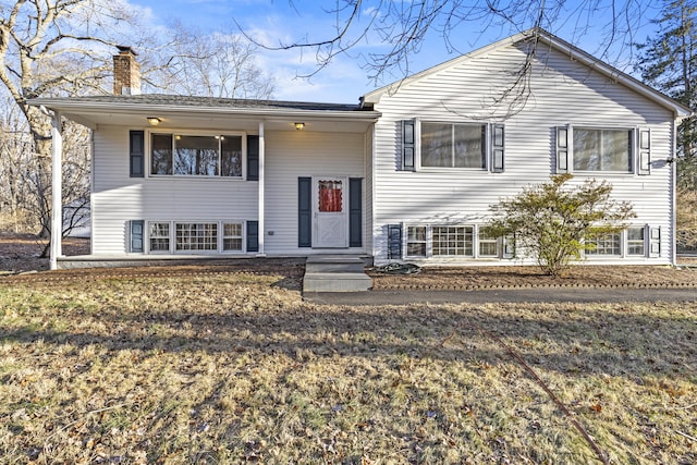 raised ranch with a front lawn