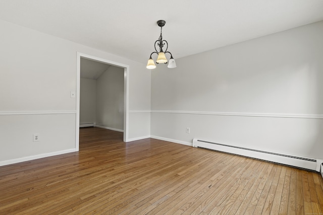 unfurnished room with wood-type flooring, a notable chandelier, and a baseboard radiator