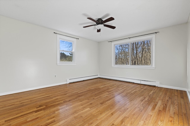 empty room featuring ceiling fan, a baseboard radiator, and light hardwood / wood-style flooring