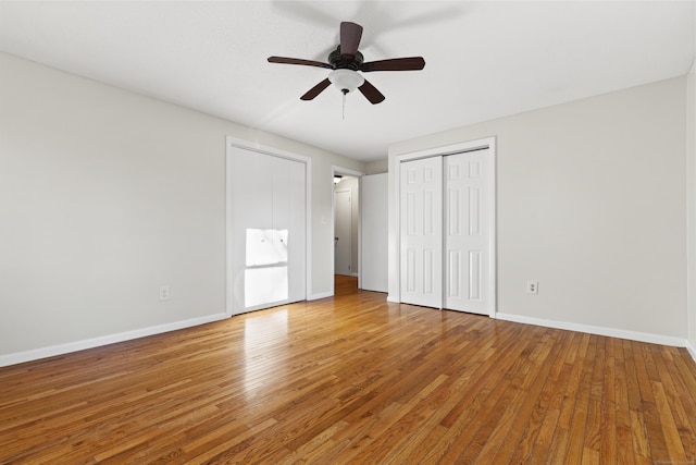 unfurnished bedroom featuring ceiling fan and hardwood / wood-style flooring