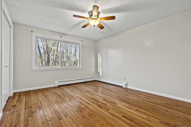 unfurnished room featuring ceiling fan, hardwood / wood-style floors, and a textured ceiling