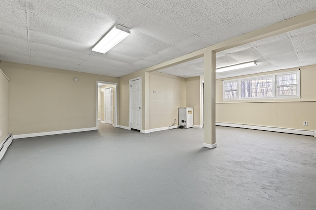 basement featuring a baseboard radiator and a paneled ceiling