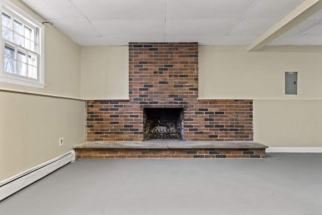 unfurnished living room featuring baseboard heating, a paneled ceiling, a fireplace, and concrete floors