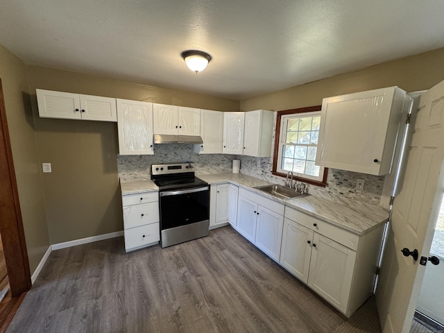 kitchen with wood-type flooring, electric range, white cabinetry, and sink