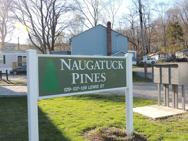 community / neighborhood sign featuring a lawn