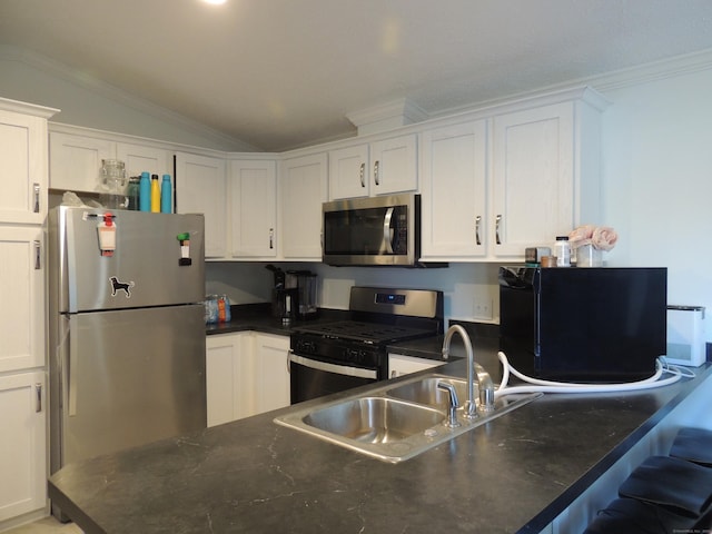 kitchen with white cabinetry, sink, vaulted ceiling, and appliances with stainless steel finishes