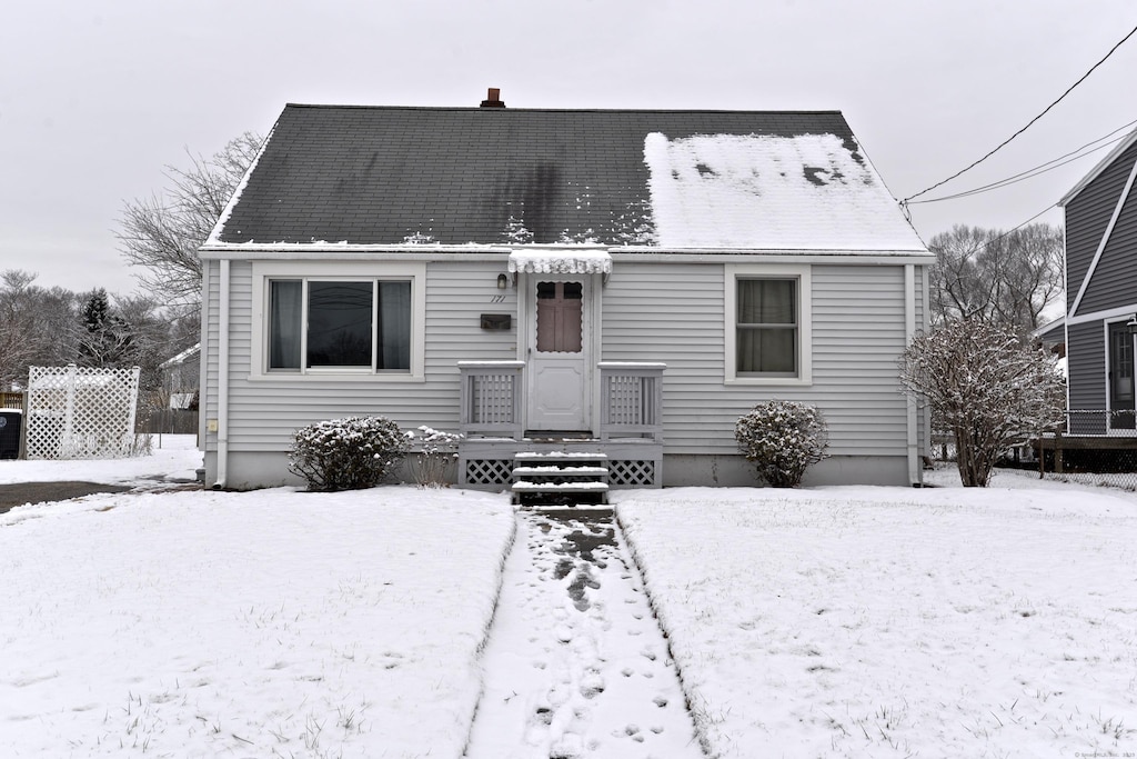 view of snow covered back of property