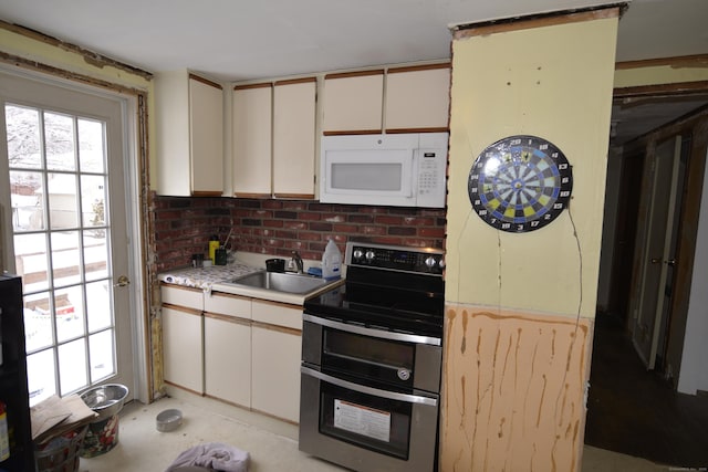 kitchen with range with two ovens and sink