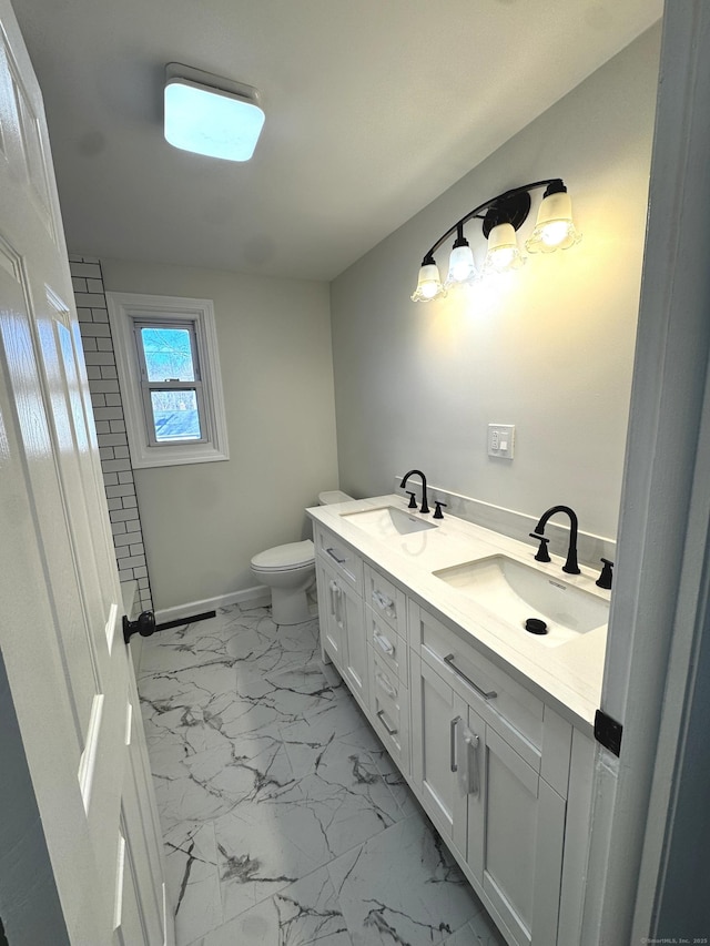 bathroom featuring toilet and vanity