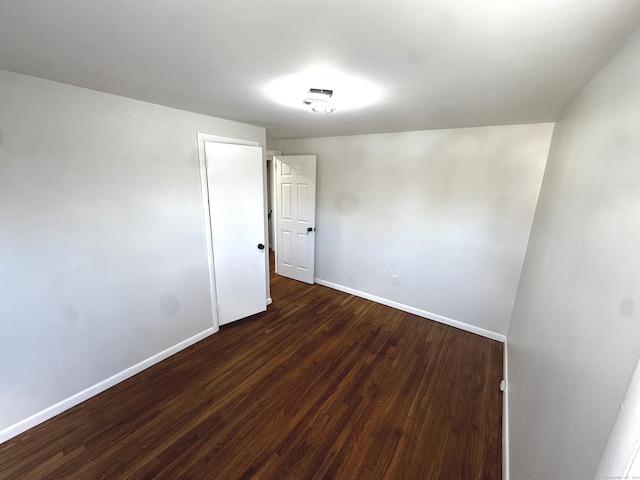 spare room with dark hardwood / wood-style floors