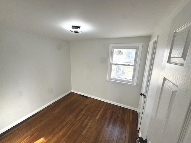 unfurnished room with dark hardwood / wood-style floors