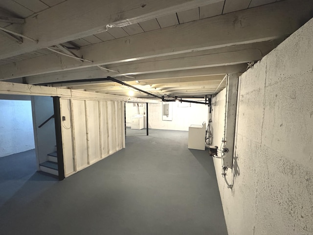 basement featuring electric panel and washer / dryer